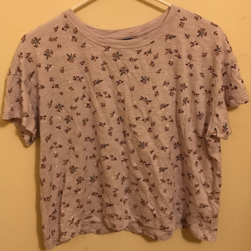 A light purple short sleeve shirt with flowers on it.